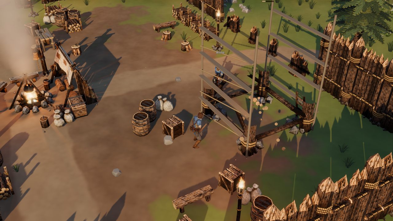 Two players building a watchtower inside the palisade: the player in a blue cloak hammers at the timber scaffold from one side while a second player, named Aline, works on the other, the Hearth's fire, a tent, crates and barrels nearby.
